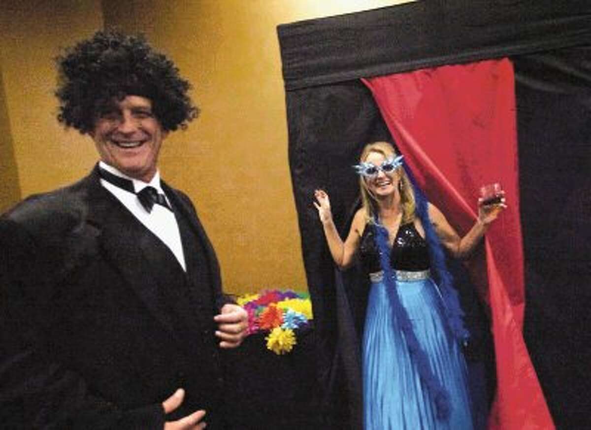 Laurie Long and Howard Perkins smile as they exit the Memorial Hermann photo booth during Saturday night's annual Greater Conroe/Lake Conroe Area Chamber of Commerce's Chairman's Ball at La Torretta Lake Resort & Spa on Lake Conroe.