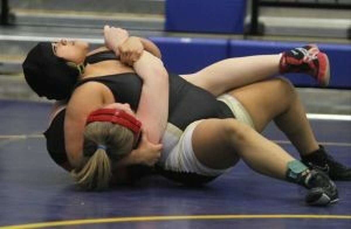 Conroe’s Nicola Newton, top, will wrestle for the Class 5A state championship today at 185 pounds.