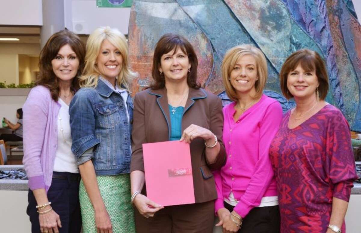 Melissa Preston and Carrie Hyman, the 2013 co-chairs of Memorial Hermann In the Pink of Health, and Megan Alexander and Ruth Hiller, the 2011-12 event co-chairs, present Trina Hans, of The Rose, with funds raised to support uninsured women in Montgomery County.
