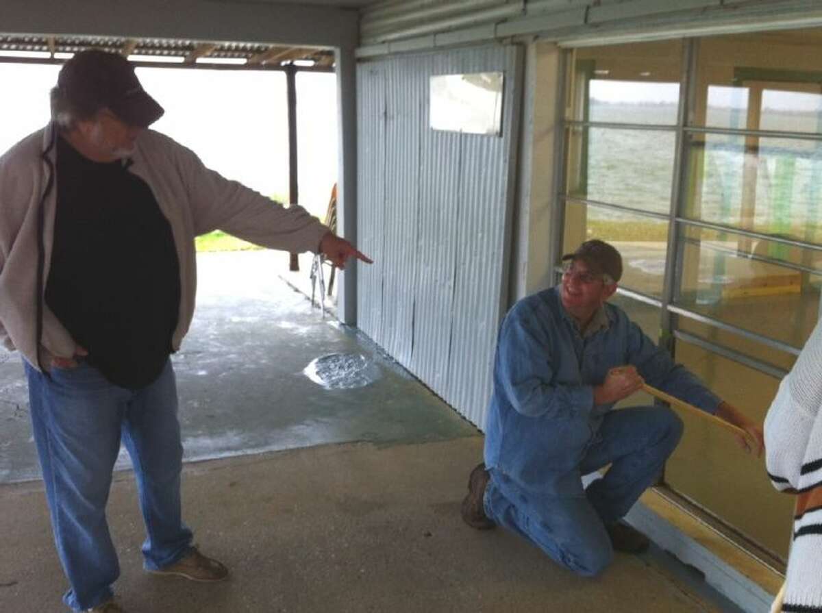 Conroe Noon Lions Club members worked on March 23 preparing the pavilion for their annual “Kids on the Lake” fishing tournament coming up May 11 at Energy Lake. Lion Duayne Freeman, left, is pointing to a flaw in Lion George Waggoner’s work.