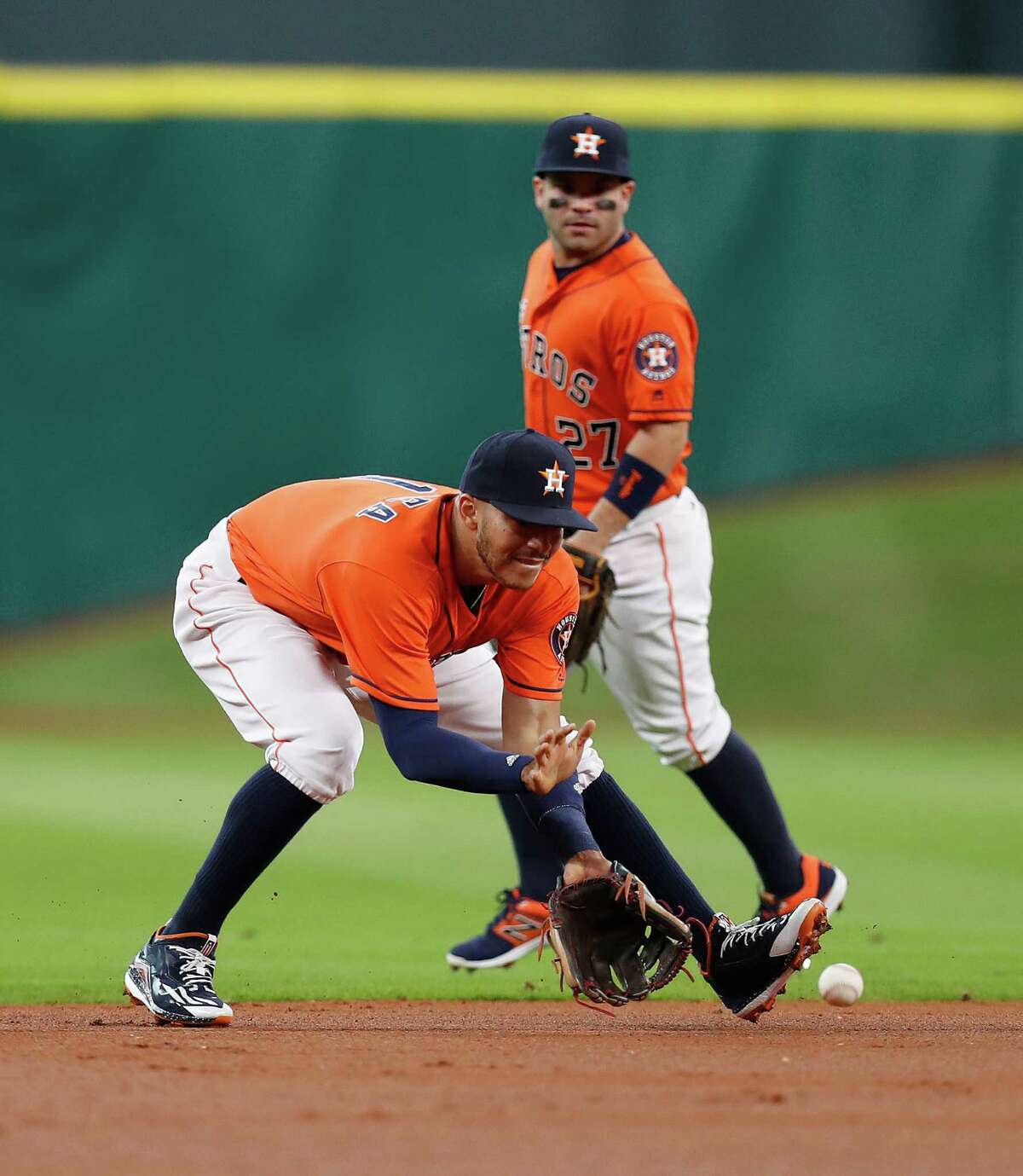 Astros shortstop Carlos Correa fields Mike Trout's grounder during the first inning Saturday. Correa aggravated a shoulder injury in Friday's loss to the Angels but was back out on the field Saturday at Minute Maid Park.