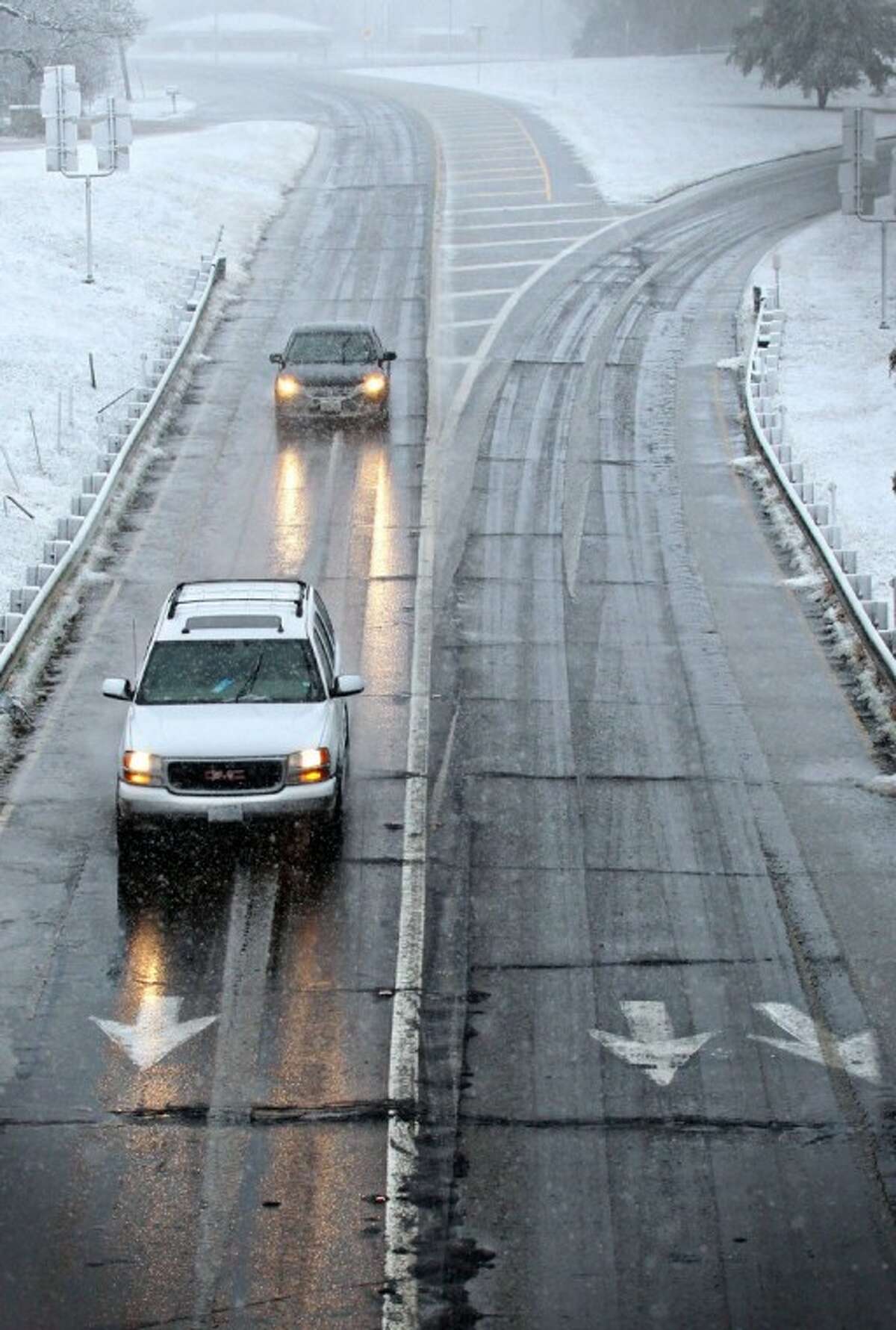 Drivers maneuver wet and icy roads in Paris, Texas, Tuesday after a strong winter system dropped inches of rain and snow on most of northeast Texas.