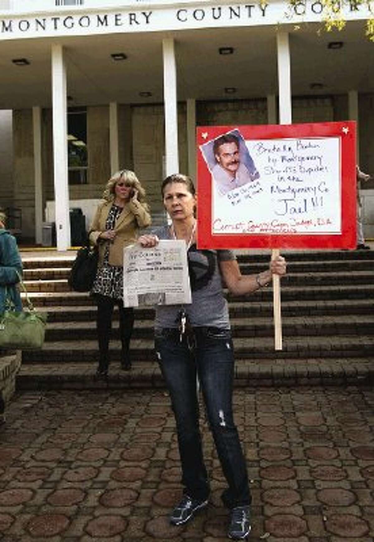 Cissy Wakat-Aikins stands in front of the county courthouse Thursday morning to create awareness surrounding the death of her brother James Mitchell. He died March 23, 2003, while in the Montgomery County Jail.