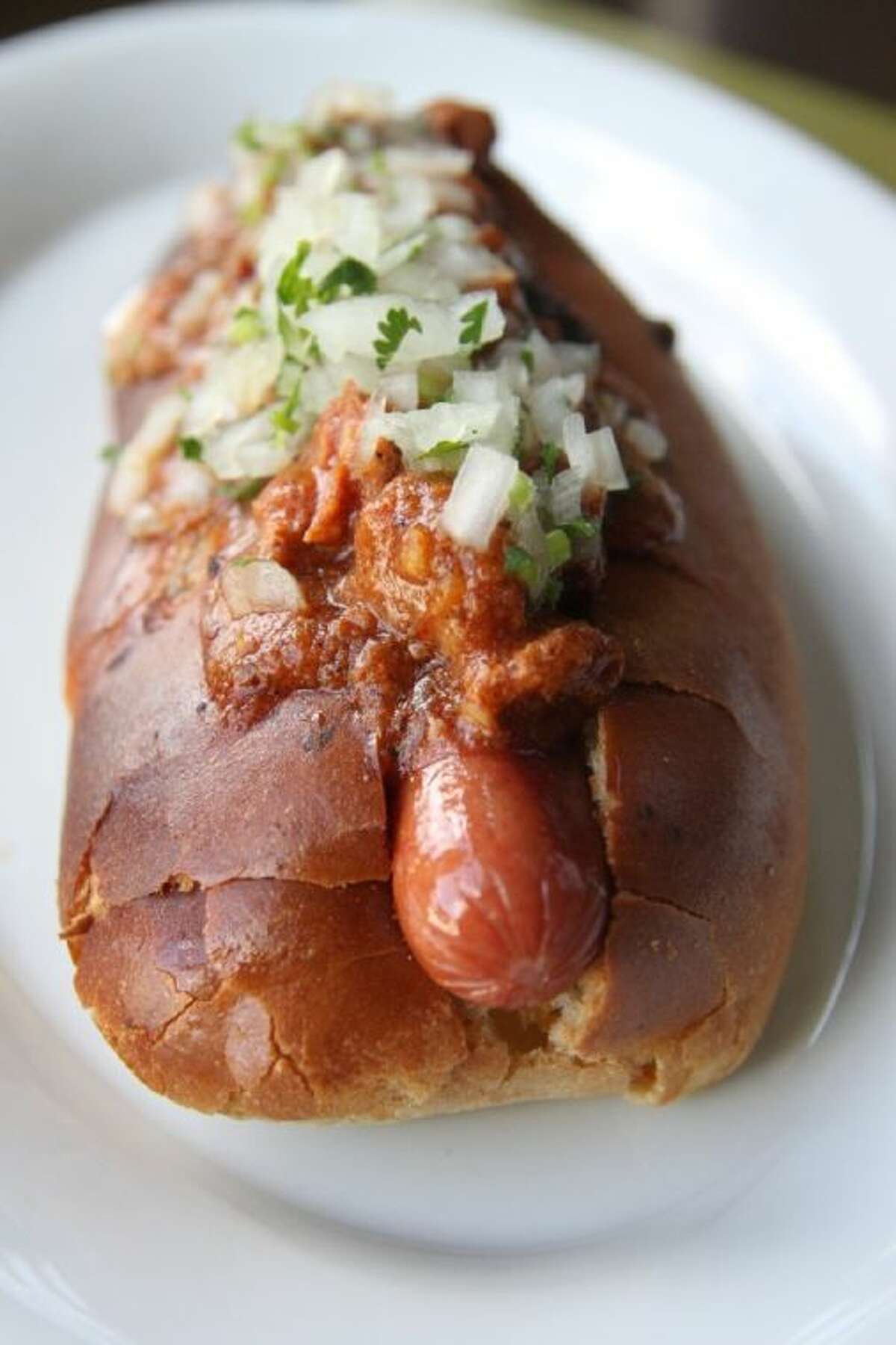 A fun designer dog comes from Chef Randy Evans at Haven — The Huntin’ Dog. It features a 100-percent Angus weiner with a jalapeno cheddar bun and loads of chili, topped with chopped onion and cilantro.