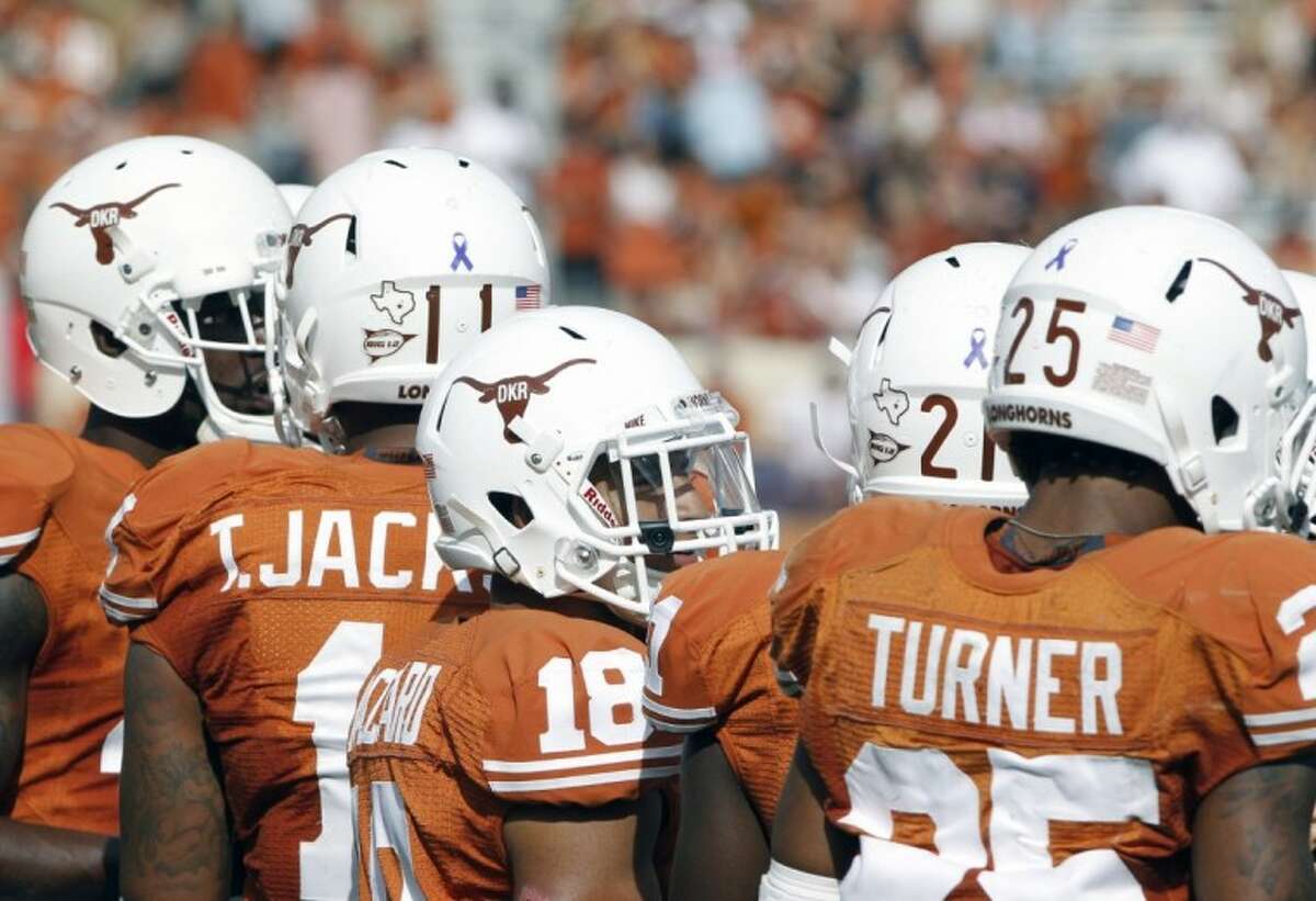 Texxas players wear a Texas Longhorn helmet logo with the initials of former head coach Darrell K Royal against Iowa State. Royal, 88, died Wednesday. The ‘Horns won 33-7.