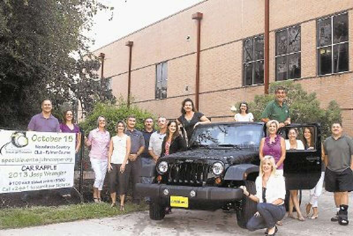 Members of the 2012 JCS Golf Tourney Committee are pictured in a Jeep Wrangler from Mac Haik: from left, David Kaczynski, Morgan Frontczak, Lyn Brus, Wendy Stearns, David Miller, Terry Taylor, Athletic Director Mike Cooper, Sue Frusco, Karen Van Buren, Carole McRobbie, Rod Pitts (chair), Nancy Wagner, Jill Harris (kneeling), Lisa Katz, Melissa Horak and Joel Bates. Committee members who are not pictured include: Dan Woodall, Iram Taylor, Polly Craddock, Rainy Chandler, Scott Heard, Sal Frusco, Todd Adam, and Tom Forestier.