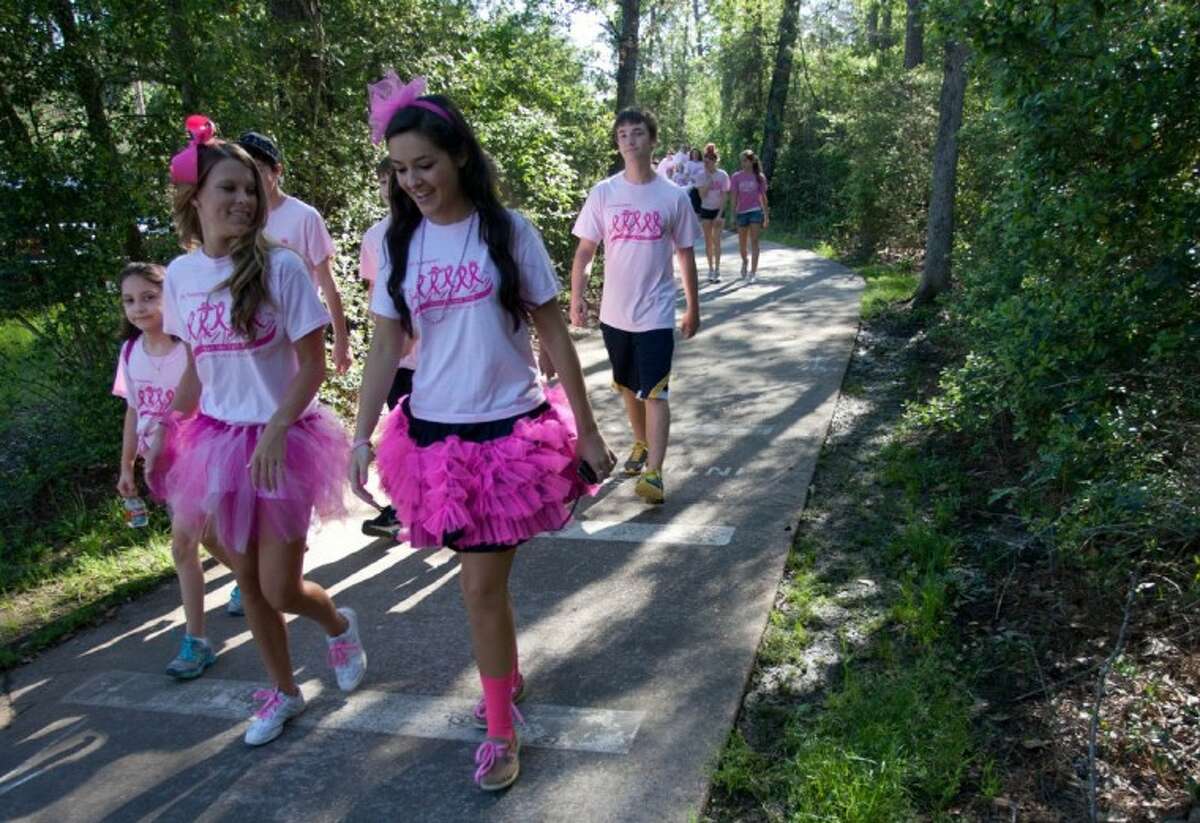 Participants take part in the 5th annual “Paint the Path Pink” event, a 3-mile charity walk at Mitchell Intermediate School benefiting breast cancer research and local victims of the deadly disease on Saturday in The Woodlands.