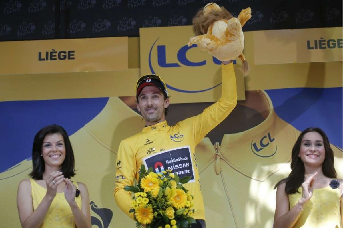 Fabian Cancellara of Switzerland, wearing the overall leader's yellow jersey, celebrates on the podium after winning the prologue of the Tour de France in Liege, Belgium, on Saturday.