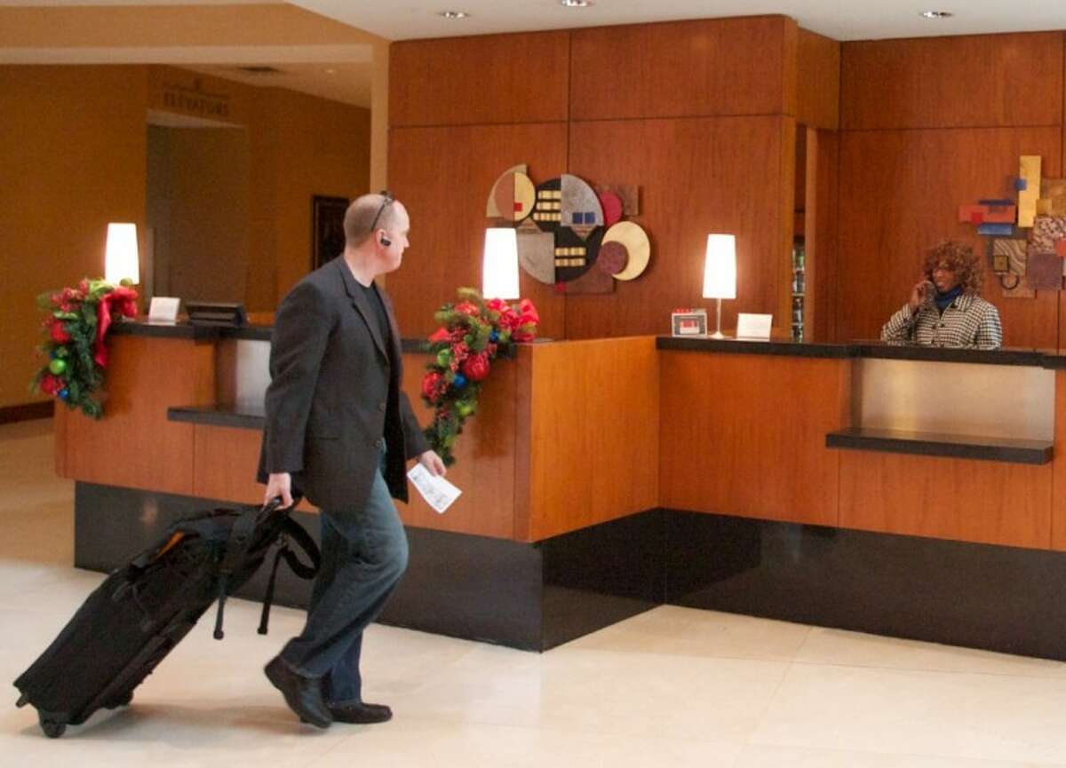 A guest prepares to check-in at the front desk of The Woodlands Waterway Marriott Hotel and Convention Center.