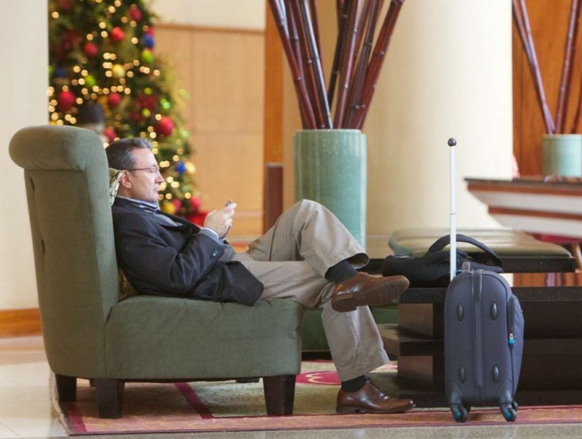 A traveller sits in the lobby of The Woodlands Waterway Marriott Hotel.