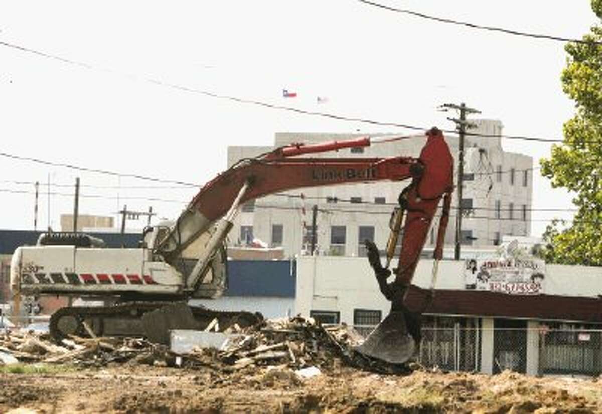 An excavator clears land for a new Fiesta Mart between North First Street and North Second Street on Conroe’s east side.