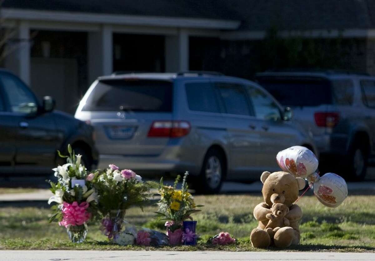Teddy bears, flowers and balloons are seen at the site where a 3-year-old girl was fatally struck by a vehicle outside her home Monday on East Legends Trail in South Montgomery County.