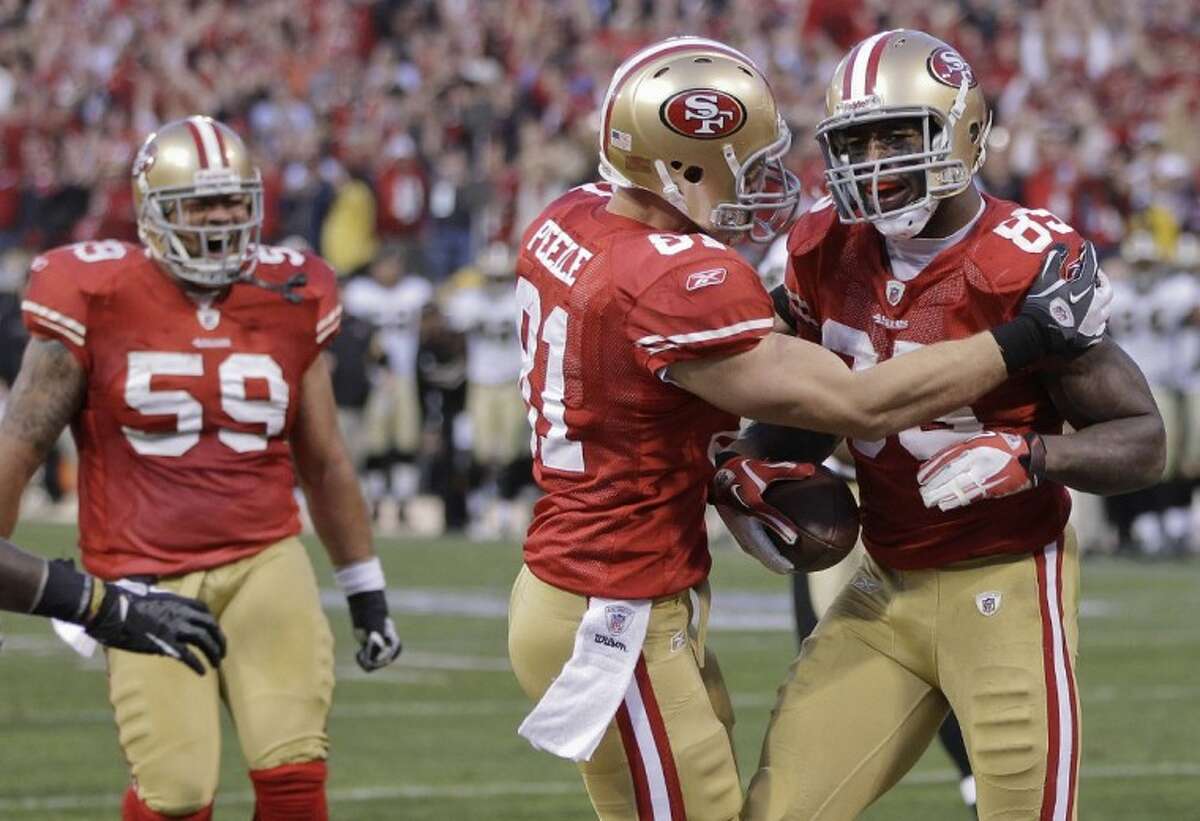 San Francisco 49ers tight end Vernon Davis celebrates with tight end Justin Peelle and guard Jonathan Goodwin after scoring on a 14-yard touchdown pass from quarterback Alex Smith against the New Orleans Saints during the fourth quarter of an NFL divisional playoff football game Saturday in San Francisco.