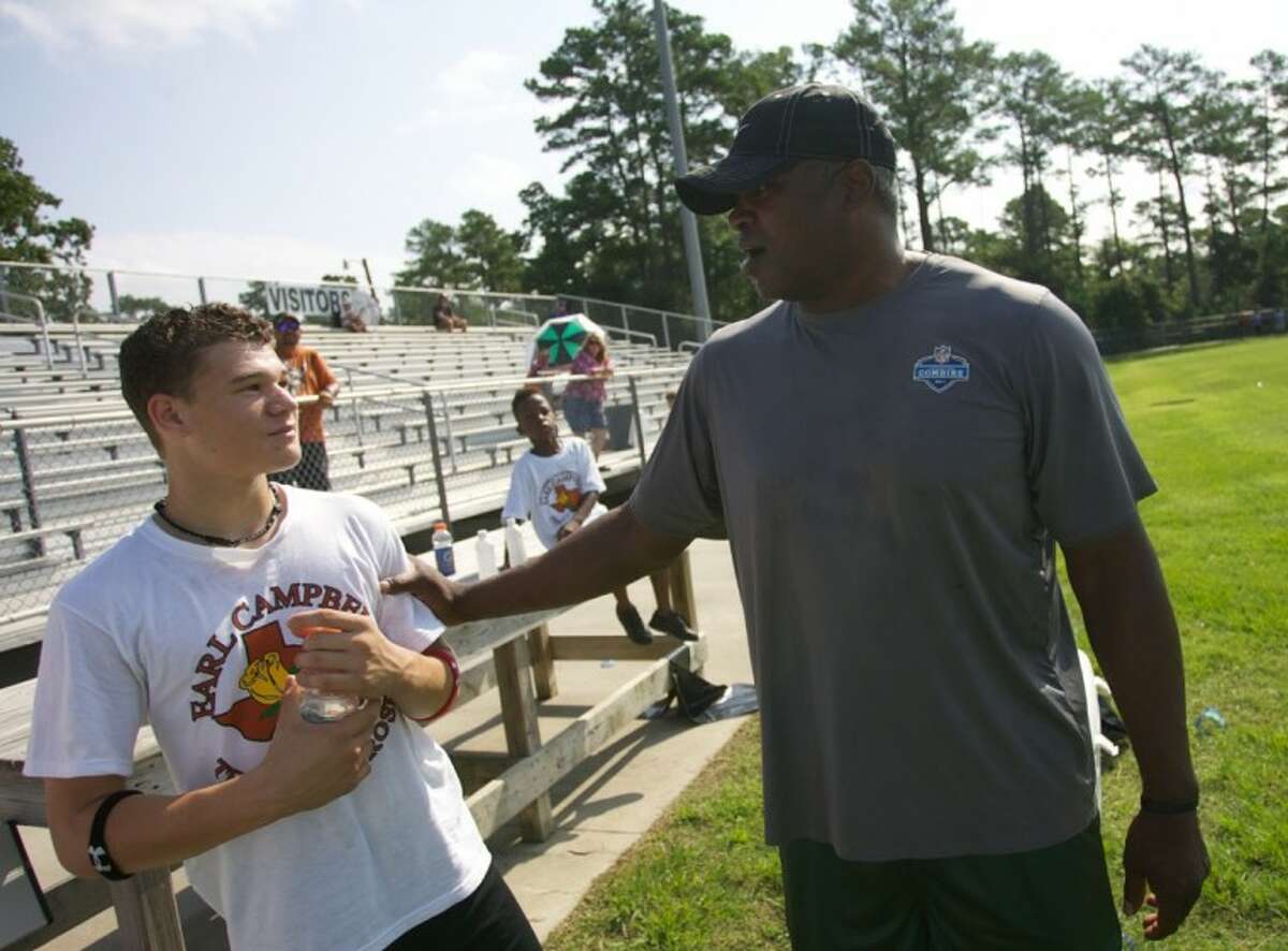 Former NFL player Alonzo Highsmith, right, chats with Jordan McGowen, 14, during Saturday’s Earl Campbell Football Combine at Conroe High School.