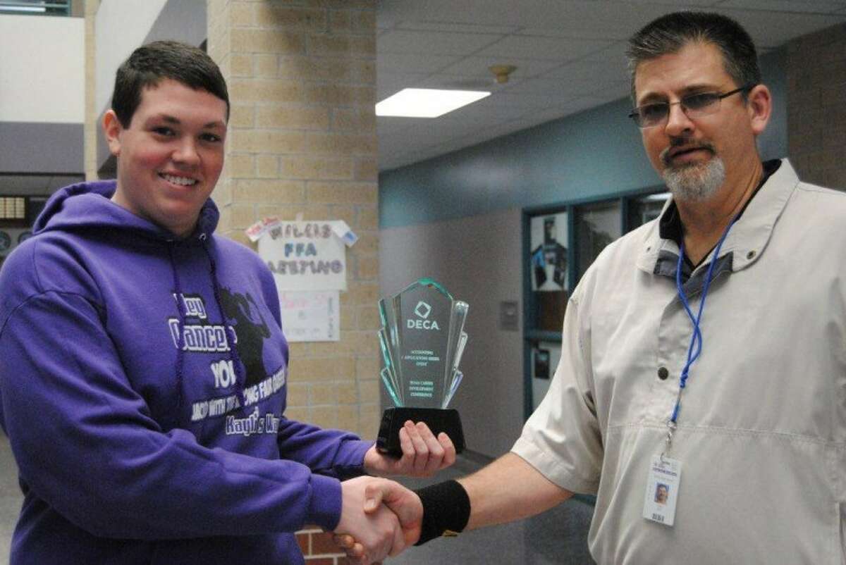 WHS Senior Bryan Moore, left, was selected to represent the state of Texas in the annual DECA International Competition in Salt Lake City Utah April 28 to May 2. Moore won the Accounting Applications section at the 2012 DECA Marketing/Business Competition in Corpus Christi March 3. WHS DECA Adviser Craig Rex, right, congratulates Moore as the first International qualifier to represent Willis High School since 2005.