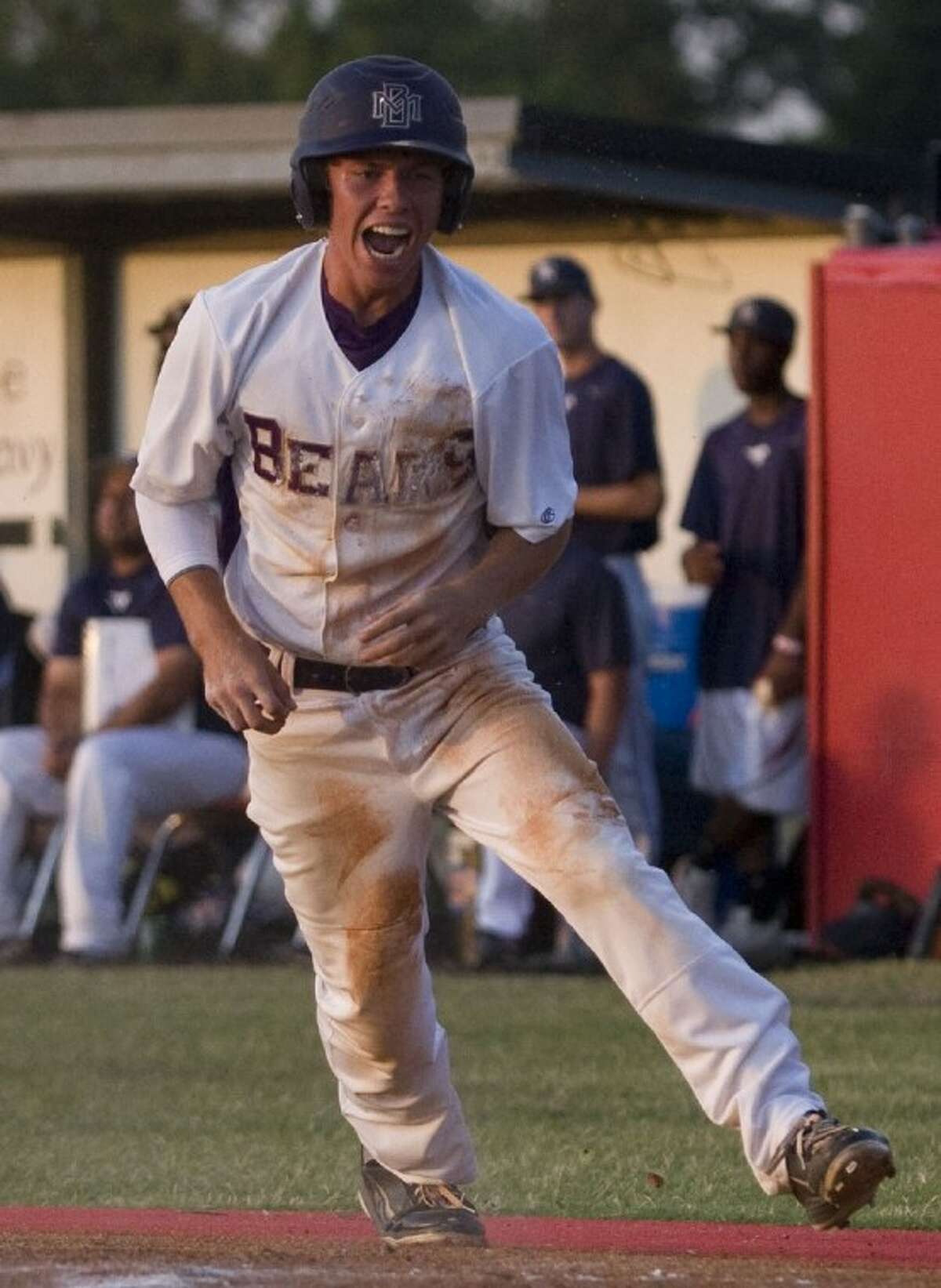 Montgomery’s Cannon Landrum celebrates after scoring the Bears’ first run on a sacrifice fly by pitcher Ty Boland in the third inning of Game 2 of the best-of-three Region III-4A final series against Lamar Consolidated last Thursday at Langham Creek High School.