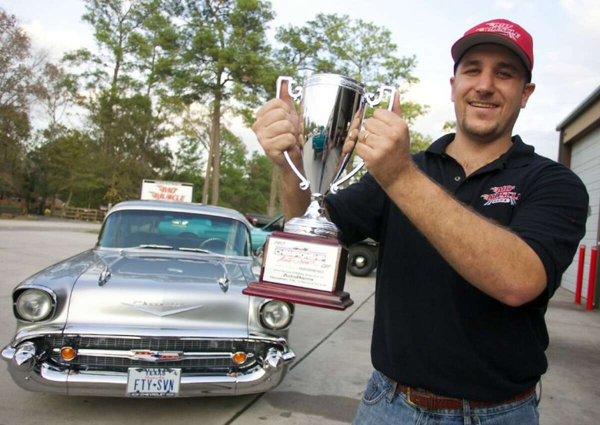 Blake Meaux holds a 2012 Houston Autorama championship trophy won by Rob Bryngelson’s 1957 Chevy rebuilt by his shop, Mo’ Muscle Cars.