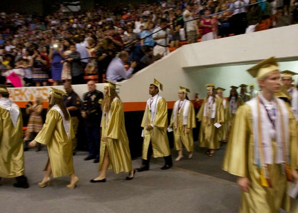 Conroe High School students enter the Johnson Coliseum for Saturday’s commencement address in Huntsville.