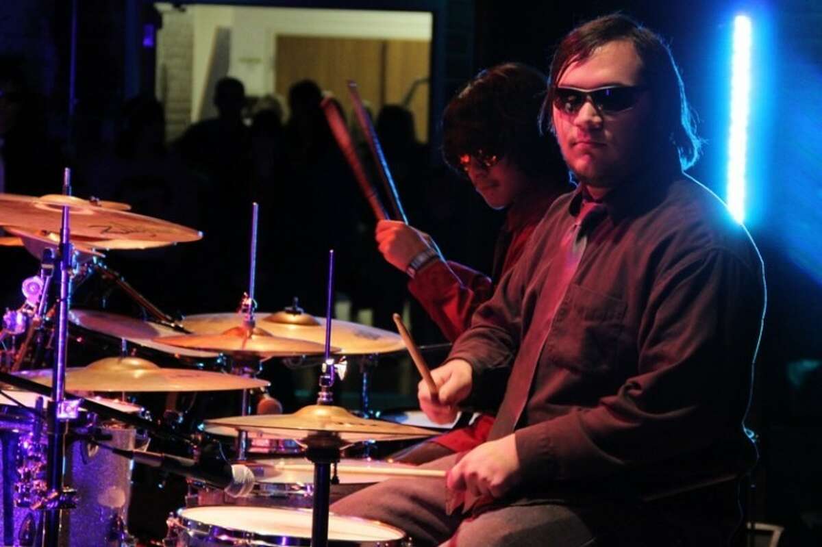 The band 'Apple Juice' pulled out two sets of drummers and a bassist for their rhythm driven performance at Conroe High School's Battle of the Band Competition.