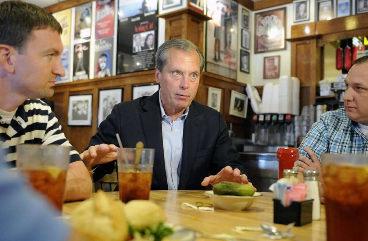 US Senate Republican primary candidate and Texas Lt. Gov. David Dewhurst visits with restaurant on election day Tuesday in Houston.