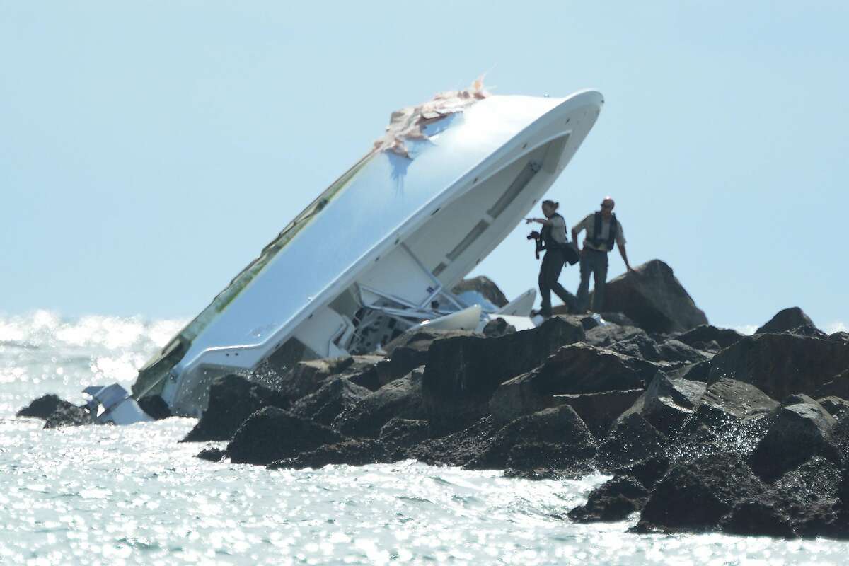 Investigators look over the overturned boat in which Miami Marlins pitcher Jose Fernandez was killed, Sunday, Sept. 25, 2016, in Maimi Beach. (Joe Caveretta/Sun Sentinel/TNS)