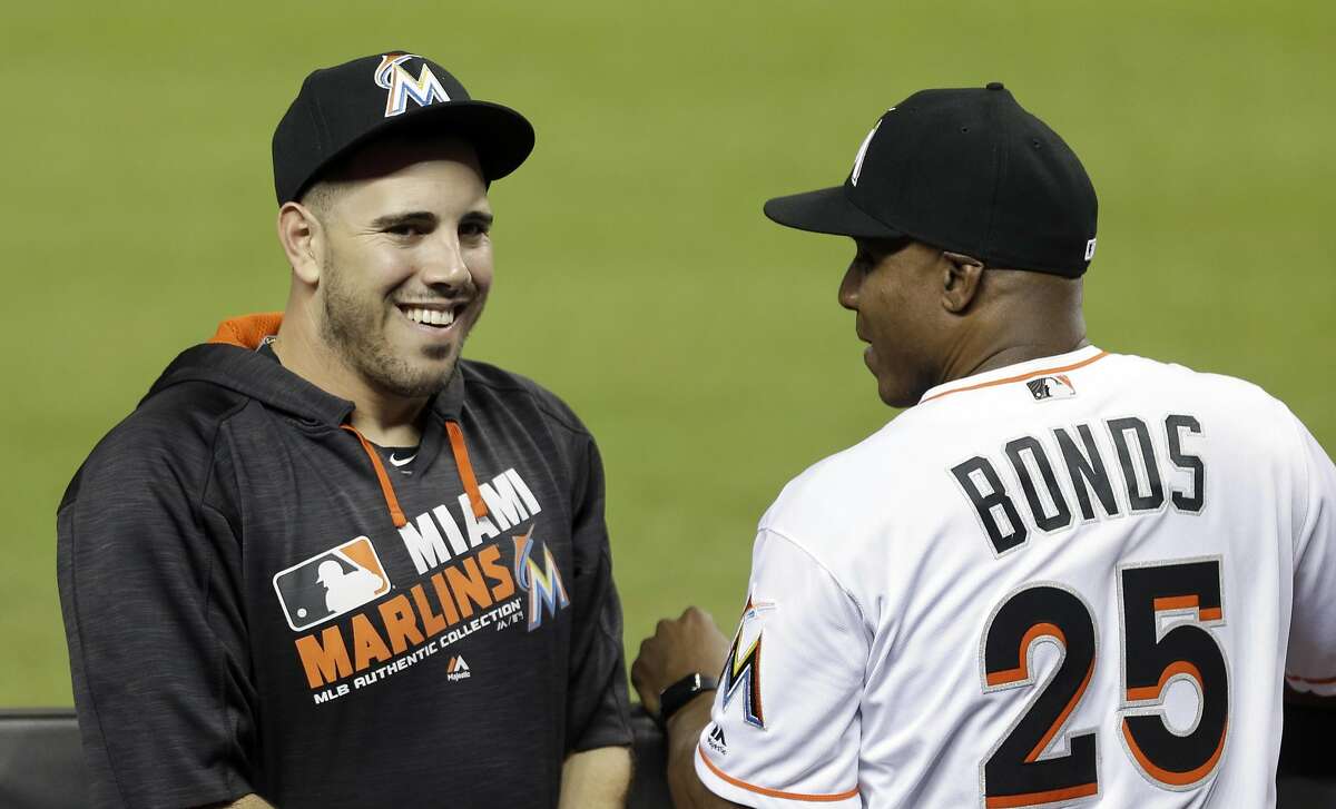 Miami Marlins' Jose Fernandez, left, talks to hitting coach Barry Bonds (25) in the dugout before a baseball game against the Atlanta Braves, Thursday, Sept. 22, 2016, in Miami. (AP Photo/Alan Diaz)