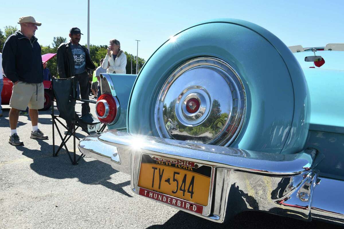 Car enthusiasts talk to Jim Connell of East Greenbush, left, about his peacock blue 1956 Ford Thunderbird at the 6th annual Times Union Hope Fund Car & Motorcycle Show in the Times Union parking lot on Sunday, Sept. 25, 2016 in Colonie, N.Y. (Lori Van Buren / Times Union)