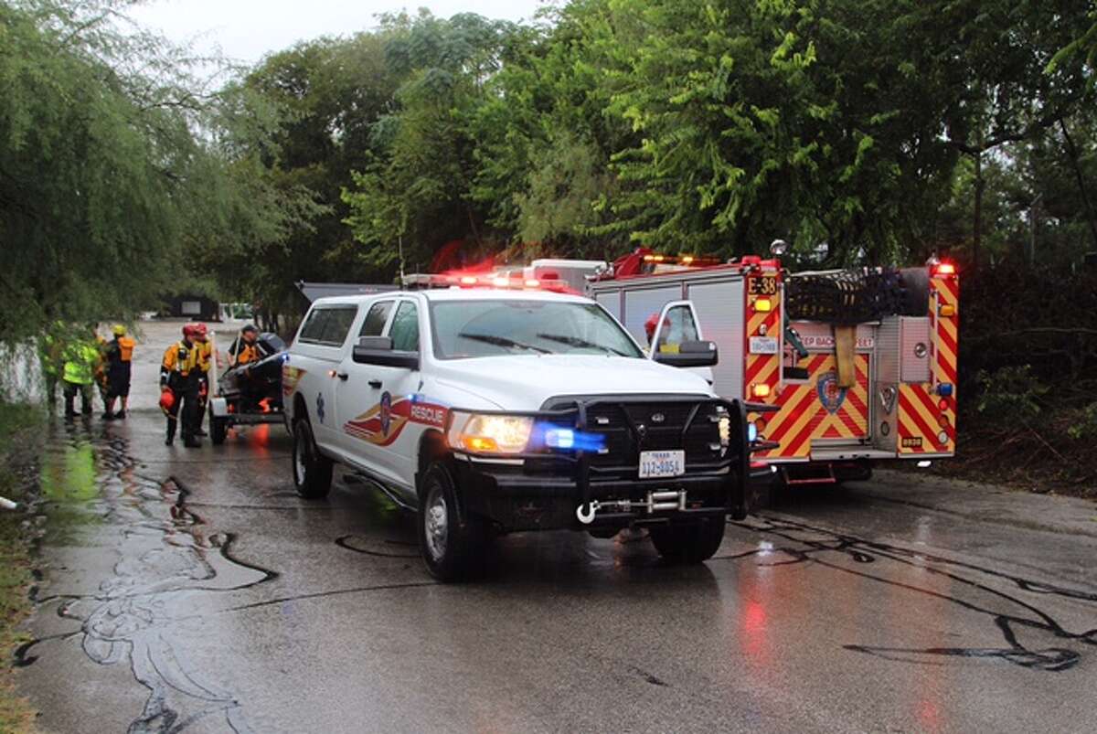 Emergency personnel rescued a garbage truck driver after large amounts of rain flooded San Antonio streets on the Northeast Side.