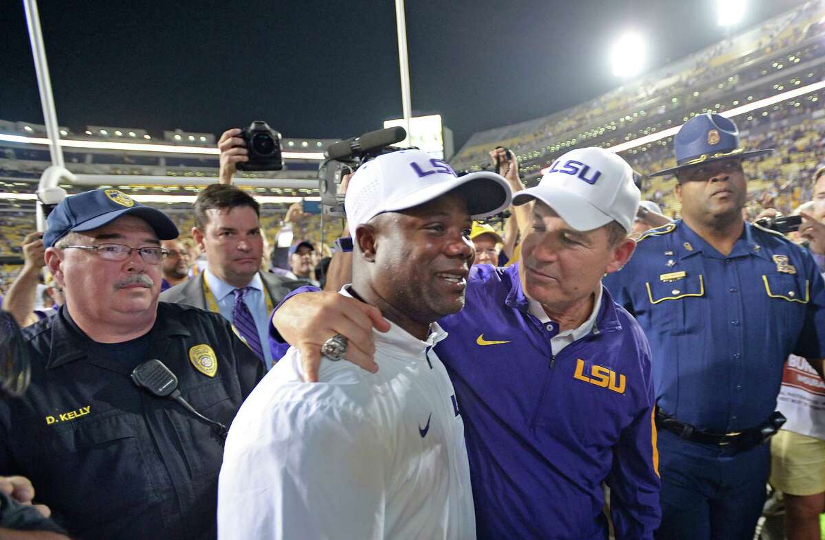 Advocate staff photo by TRAVIS SPRADLING -- LSU head coach Les Miles puts his arm around running backs coach Frank Wilson, left, as they head to the tunnel after the LSU-Texas A&M football game in Baton Rouge, Saturday, Nov. 28, 2015. LSU won, 19-7, and LSU running back Leonard Fournette (7) broke the team single season rushing record that night.