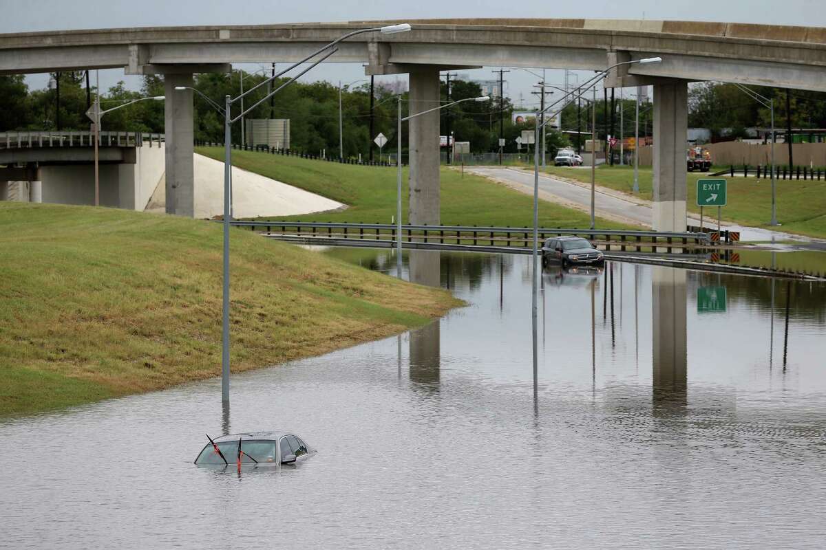 Vehicles are left stranded in high water along General Hudnell Drive east of Port San Antonio after heavy rains cause flooding throughout San Antonio, Monday, Sept. 26, 2016. The San Antonio Fire Department responded to over 40 water rescues throughout the morning.