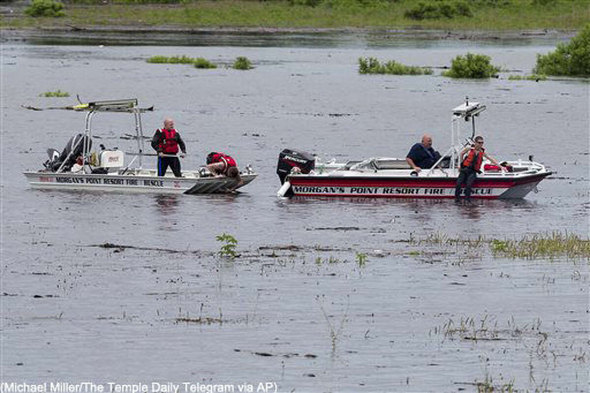Morgan's Point Resort Fire and Rescue works on Lake Belton near the scene of an accident at Fort Hood at Owl Creek Park near Gatesville, Texas, on Thursday, June 2, 2016. Fort Hood says several soldiers are dead and six are missing after an Army troop truck was washed from a low-water crossing and overturned in a rain-swollen creek at Fort Hood in Central Texas. A statement from the Texas Army post says the accident happened about 11:30 a.m. Thursday in an area near Cold Springs and Owl Creek. (Michael Miller/The Temple Daily Telegram via AP) MANDATORY CREDIT