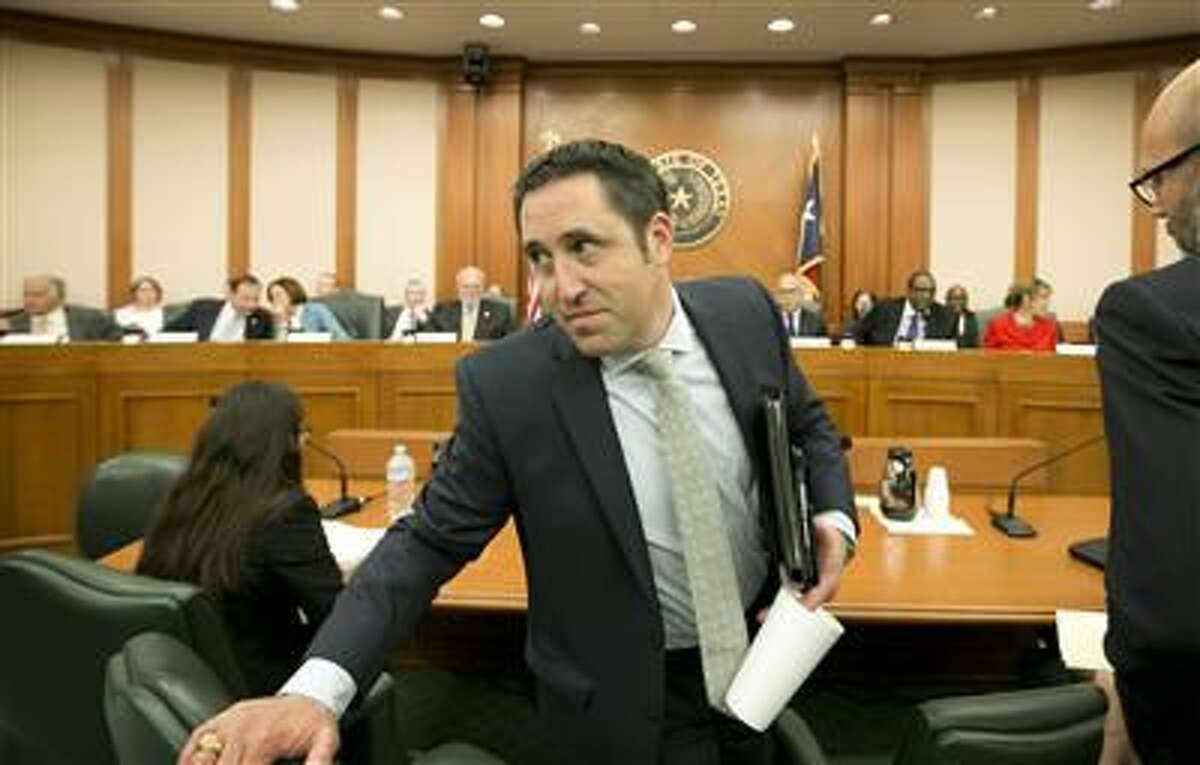 Texas Comptroller Glenn Hegar gets up after testifying about the effects of declining oil prices on the state budget at a hearing in 2016 in Austin.