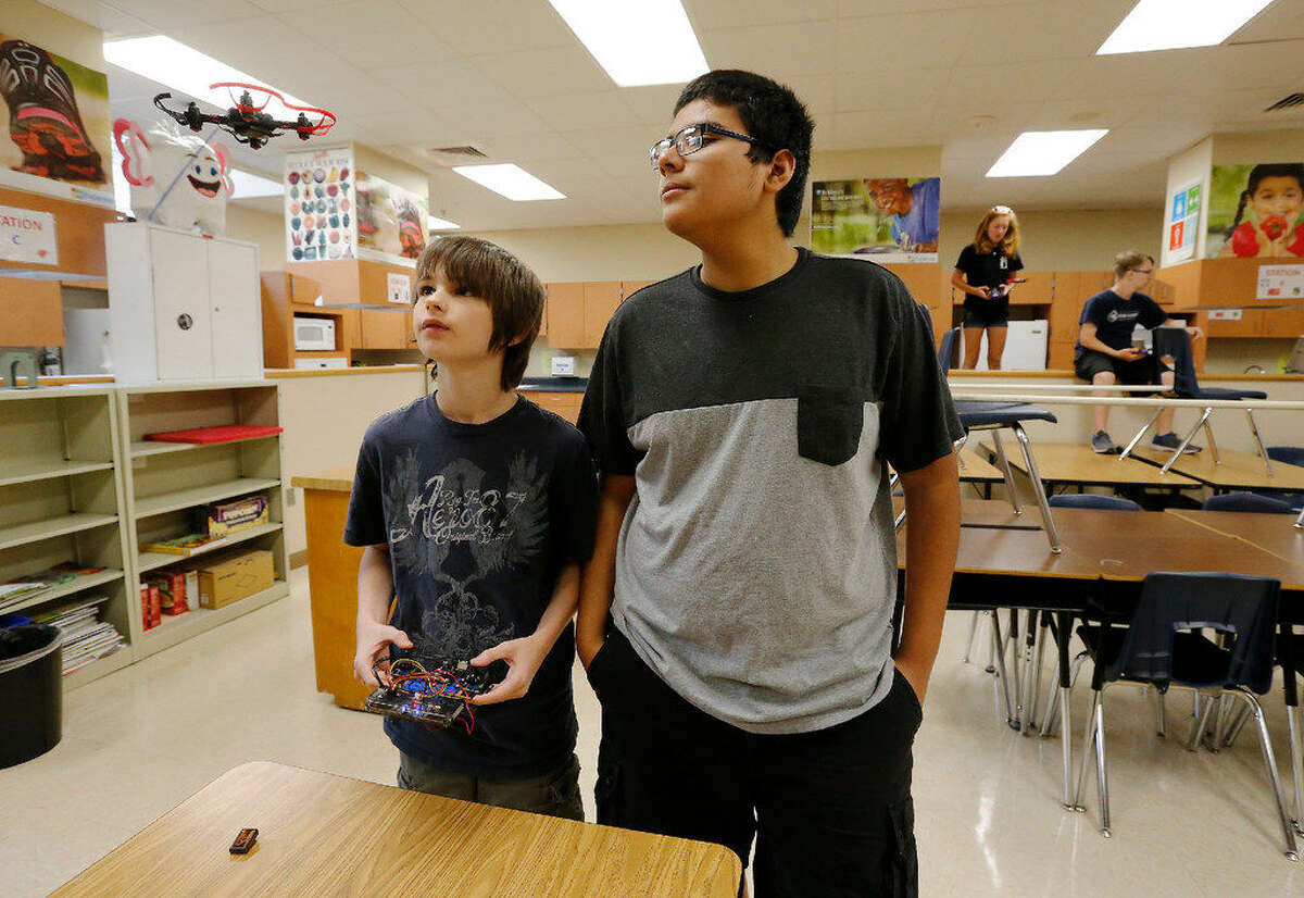 Incoming Roosevelt High School freshmen Connor Mellor (left) and Brandon Ochoa keep an eye on their drone as 25 NEISD middle and high school students attend Drone Camp where students build and program their own drones. On Thursday, July 28, 2016, the last day of camp, students flew their drones through a makeshift obstacle course at Roosevelt High School. The students consisted of middle and high school NEISD students. Many attend Ed White Middle School and Roosevelt High School's magnet programs: Design and Technology Academy (DATA) and Engineering and Technology Academy (ETA). Sponsor CoDrone just got off Kickstarter and the district was one of the first in the country to host a camp according to the official press release. (Kin Man Hui/San Antonio Express-News)
