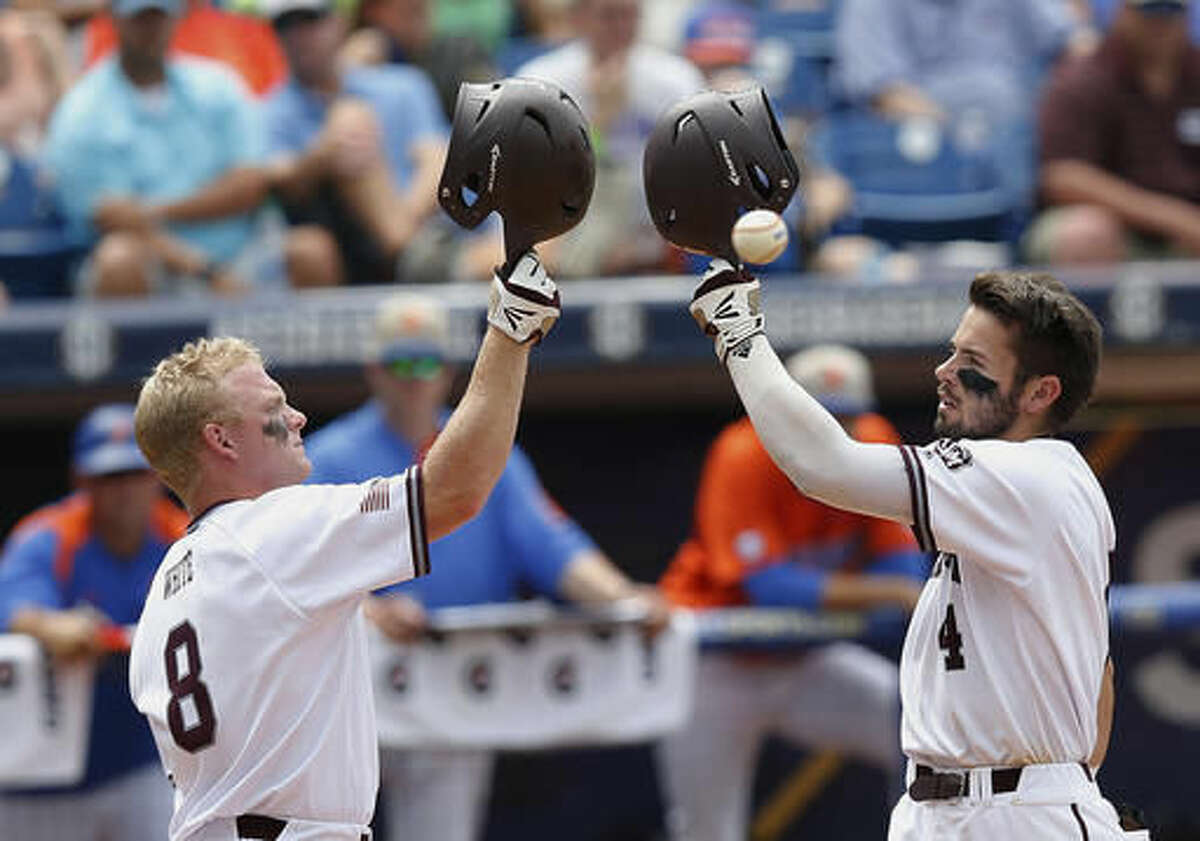 Texas A&M's Nick Banks, right, celebrates with Boomer White after Banks hits a solo home run in the third inning of the Southeastern Conference NCAA college baseball championship game at the Hoover Met, Sunday, May 29, 2016, in Hoover, Ala. Texas A&M won 12-5. (AP Photo/Brynn Anderson)