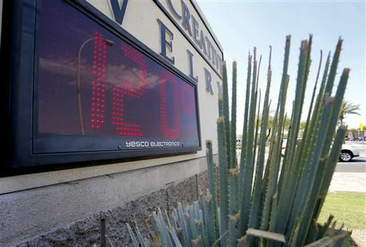 FILE - In this June 20,2016 file photo, a sign, in direct sunlight, indicates 120 degrees, in Phoenix. Federal meteorologists say America’s warm, wild and costly weather broke another record this summer: hottest June. June’s average temperature in the Lower 48 states was 71.8 degrees, 3.3 degrees above normal, passing the Dust Bowl record set in 1933. National Oceanic and Atmospheric Administration climate scientist Jake Crouch says the nation has been quite hot all year with natural variability and long-term warming cause June’s heat. (AP Photo/Matt York, File)