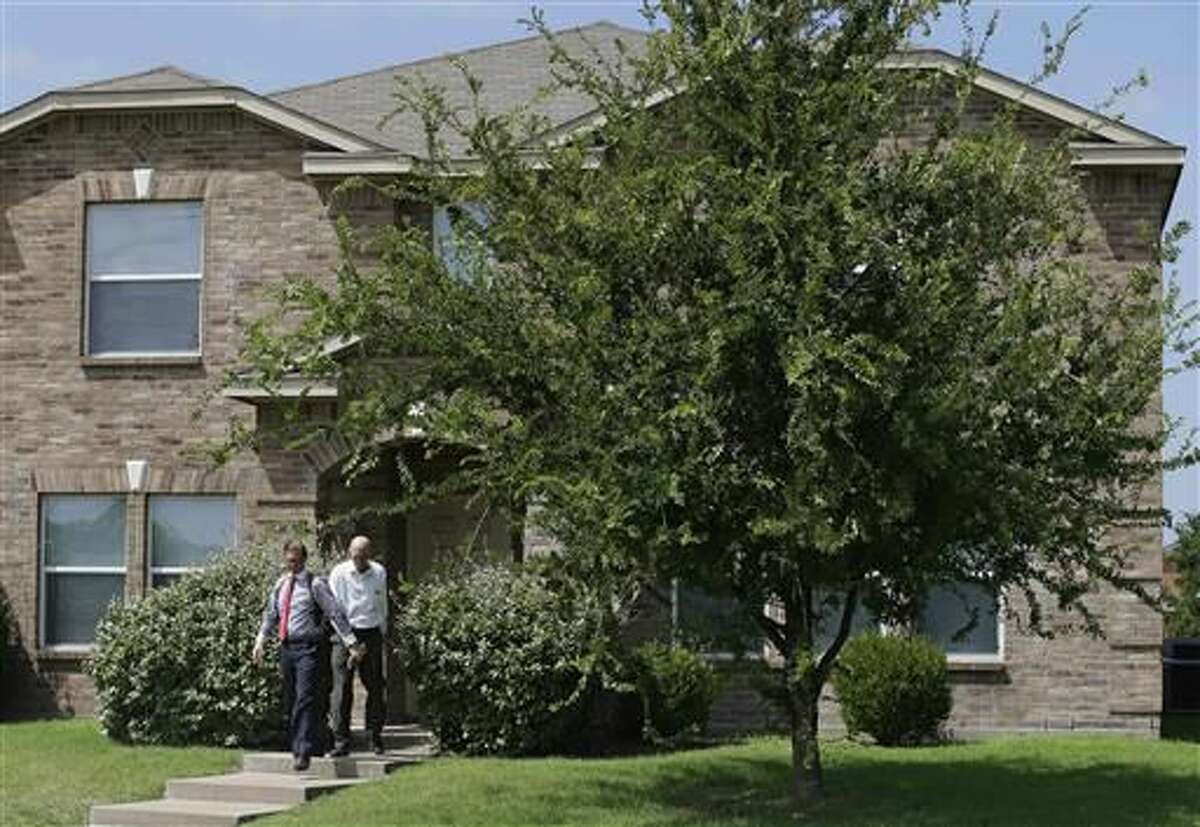 Investigators leave the home of Micah Xavier Johnson in the Dallas suburb of Mesquite, Texas, Friday, July 8, 2016. A Texas law enforcement official identified Johnson, 25, as the sniper who opened fire on police officers in the heart of Dallas during protests over two recent fatal police shootings of black men. (AP Photo/LM Otero)  