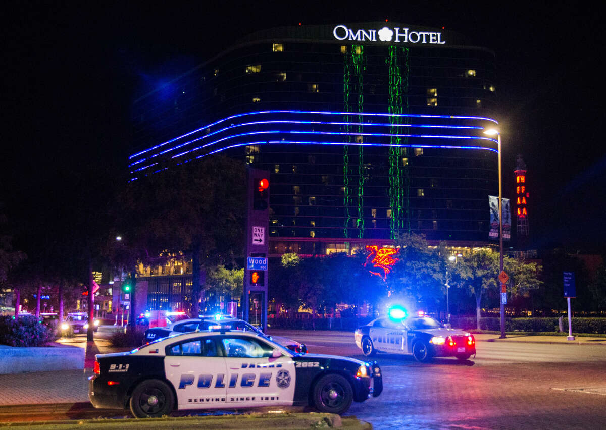 The Omni Hotel displays a blue stripe over police vehicles to show solidarity with Dallas police on Thursday, July 7, 2016 in Dallas. Snipers opened fire on police officers in the heart of Dallas during protests over two recent fatal police shootings of black men. (Ashley Landis/The Dallas Morning News via AP)