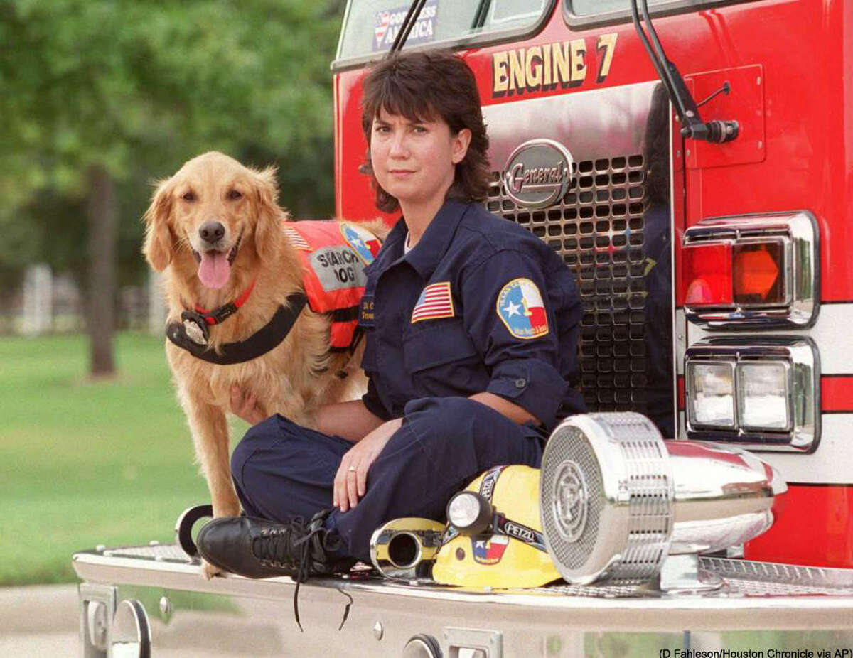 This Sept. 11, 2002, photo shows, K9 Search Specialist Denise Corliss and her search dog Bretagne in Houston, Texas. Bretagne the last known living 9/11 search dog has died in a Houston suburb at age 16. Bretagne was 2 years old when she and her handler, Corliss, were part of the Texas Task Force 1 sent to the World Trade Center site in Lower Manhattan after the terrorist attack brought down the buildings on Sept. 11, 2001. (D Fahleson/Houston Chronicle via AP) MANDATORY CREDIT