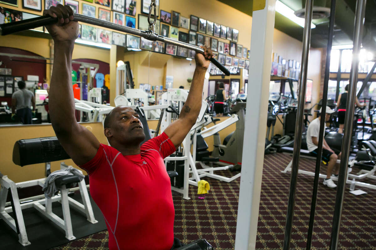 Mark Bryant, who lives in Seattle’s works on lat pulls at Columbia City Fitness, where he teaches.