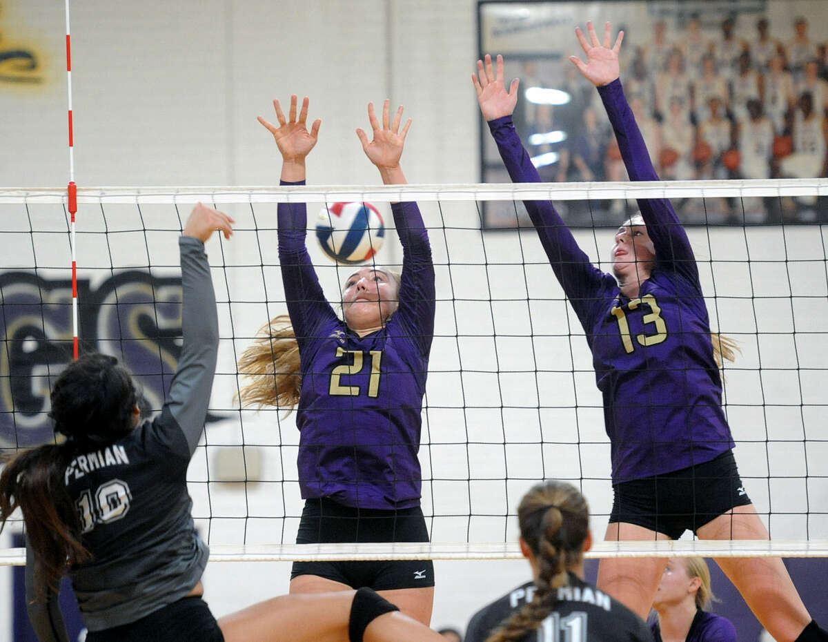 Midland's Kathryn Herd (21) and Merrick Beach (13) try to block a hit from Permian's Tristiana Abila (10) on Tuesday, Sept. 13, 2016 at Midland High. James Durbin/Reporter-Telegram