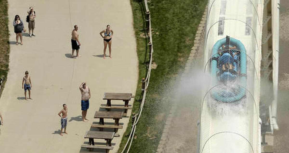 FILE - In this July 9, 2014 file photo, riders are propelled by jets of water as they go over a hump while riding a water slide called "Verruckt" at Schlitterbahn Waterpark in Kansas City, Kan. A 12-year-old boy died Sunday, Aug. 7, 2016, on the Kansas water slide that is billed as the world's largest, according to officials. Kansas City, Kansas, police spokesman Officer Cameron Morgan said the boy died at the Schlitterbahn Waterpark, which is located about 15 miles west of downtown Kansas City, Missouri. Schlitterbahn spokeswoman Winter Prosapio said the child died on one of the park's main attractions, Verruckt, a 168-foot-tall water slide that has 264 stairs leading to the top. (AP Photo/Charlie Riedel, File)