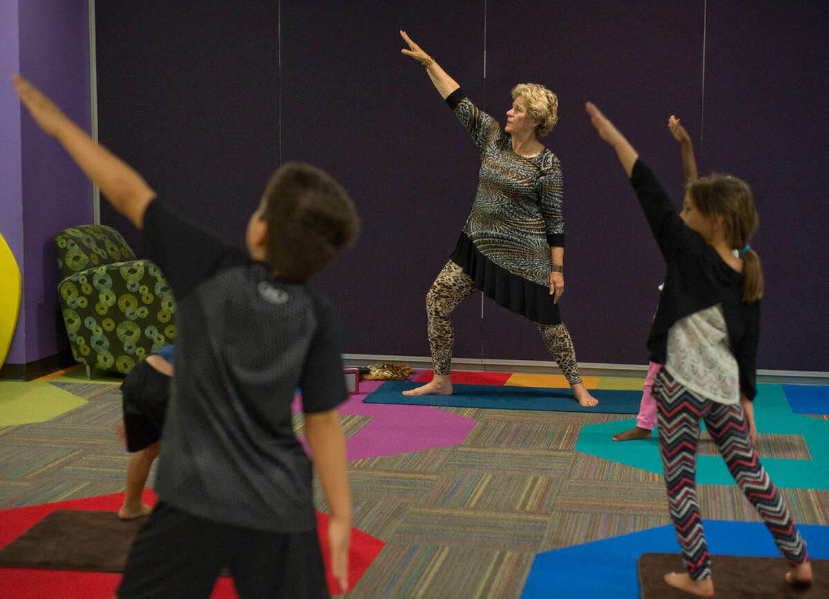 Anne Lucero leads a kids' yoga class. Lucero's Yoga Sanctuary will host a series of workshops led by a meditation guide from India. The classes will begin Thursday.