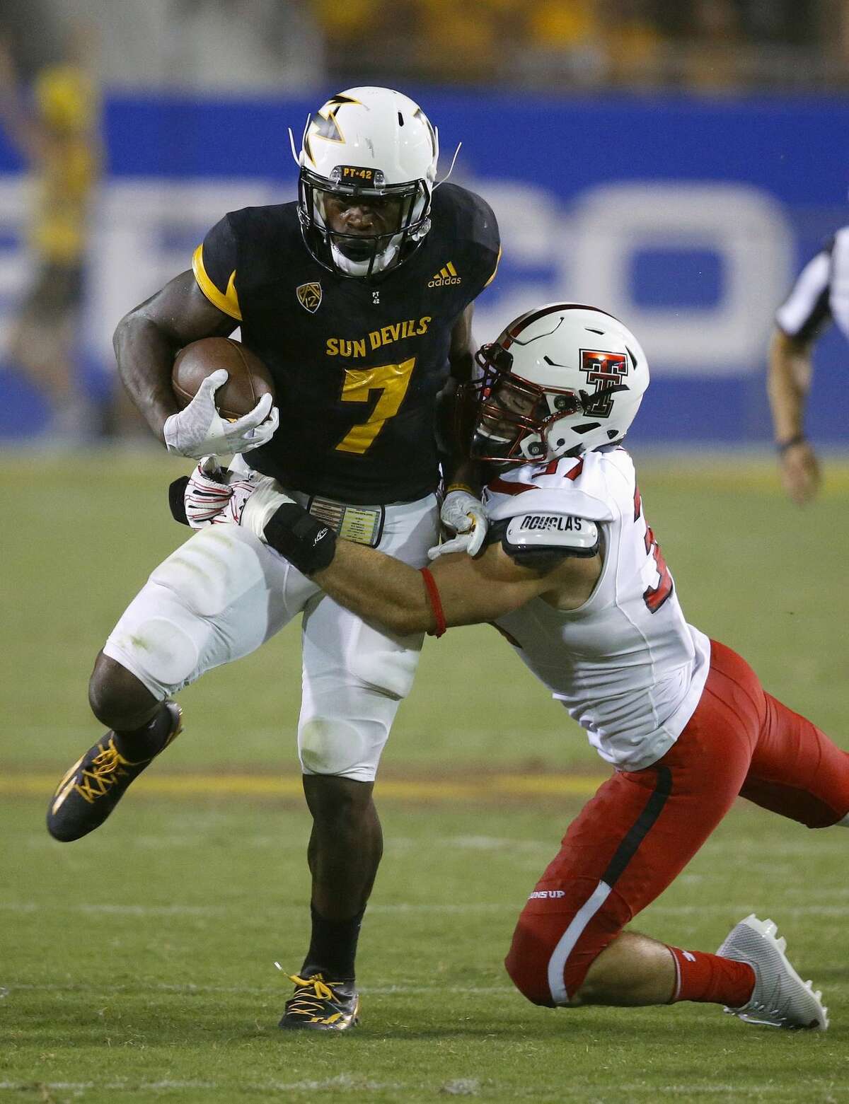 Arizona State's Kalen Ballage (7) runs with the ball as Texas Tech's Luke Stice, right, comes in for the tackle during the second half of an NCAA college football game Saturday, Sept. 10, 2016, in Tempe, Ariz. Arizona State defeated Texas Tech 68-55. (AP Photo/Ross D. Franklin)