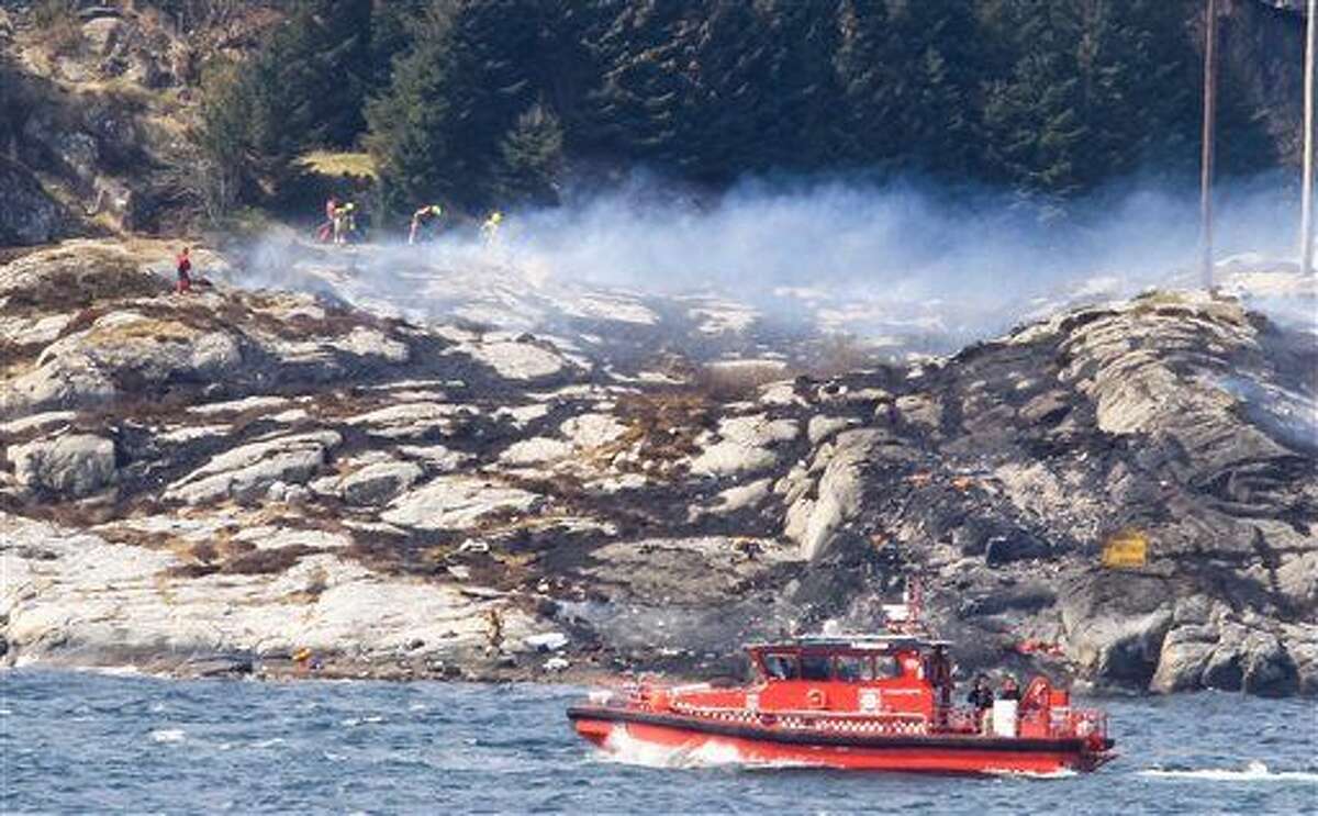 A search and rescue vessel patrols off the island of Turoey, near Bergen, Norway, as emergency workers attend the scene of a helicopter crash believed to have 13 people aboard, Friday April 29, 2016. The helicopter carrying around 13 people from an offshore oil field crashed Friday near the western Norwegian city of Bergen, police said. Many are feared dead. (Rune Nielsen / NTB scanpix via AP) NORWAY OUT