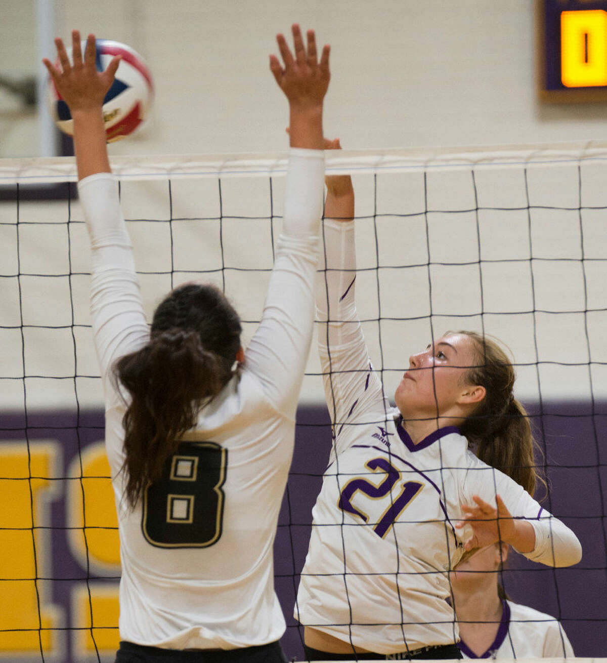 Midland High's Kathryn Herd puts a shot past the reach of Lubbock High's Elise Norris Tuesday 08-16-16 in a pre-season match at MHS gym. Tim Fischer/Reporter-Tel­egram