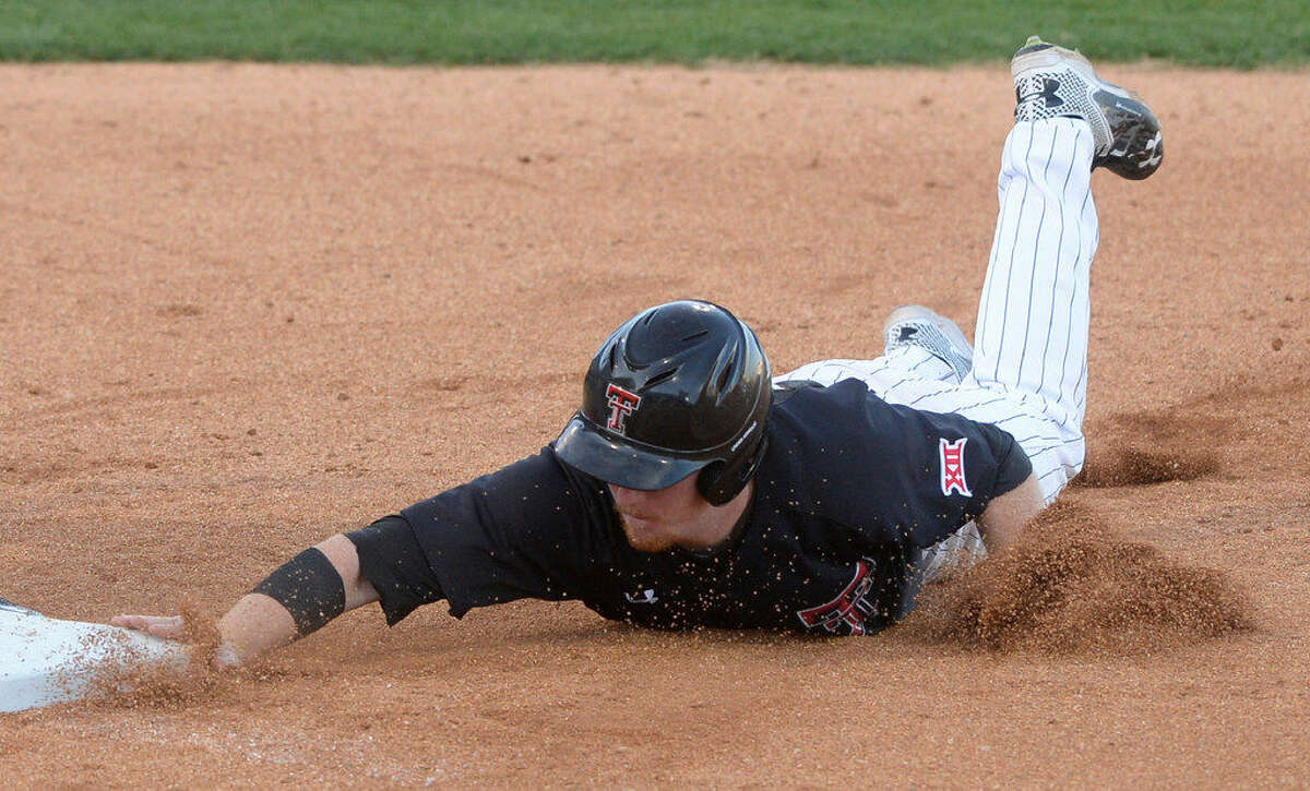 Texas Tech's Hunter Hargrove (25) slides back to first base on a pickoff attempt by Abilene Christian on Wednesday, April 27, 2016, at Security Bank Ballpark. James Durbin/Reporter-Tele­gram