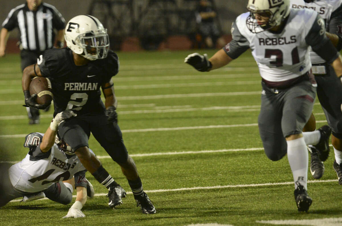 Permian's Kobe Robinson tries to get away from Lee High's Tristan Martinez as Ryan Dean comes in to help stop him Friday 10-9-2015 at Ratliff Stadium. Tim Fischer\Reporter-Telegram