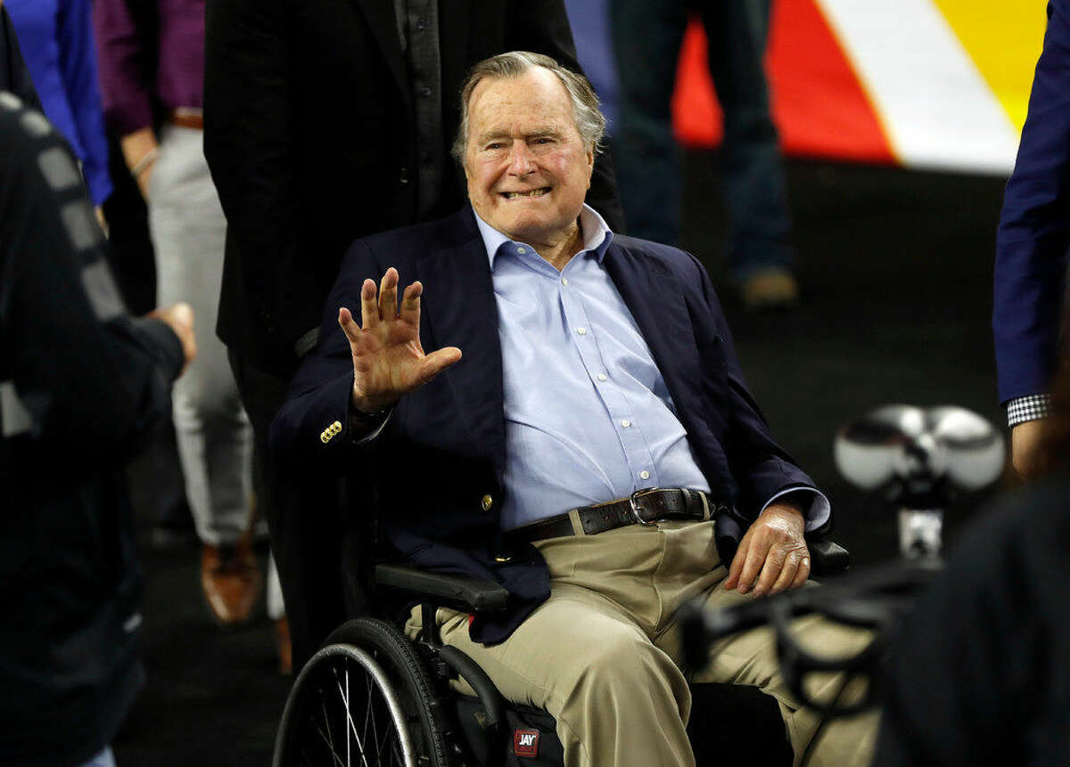 Former President George H. W. Bush waves as he arrives at NRG Stadium before the NCAA Final Four tournament college basketball semifinal game between Villanova and Oklahoma Saturday, April 2, 2016, in Houston. Kathleen Kennedy Townsend, daughter of Robert F. Kennedy Jr., posted a photo on Facebook on Monday, showing her shaking hands with former President George H.W. Bush. The photo carried this caption: “The president told me he’s voting for Hillary!!”(AP Photo/David J. Phillip)