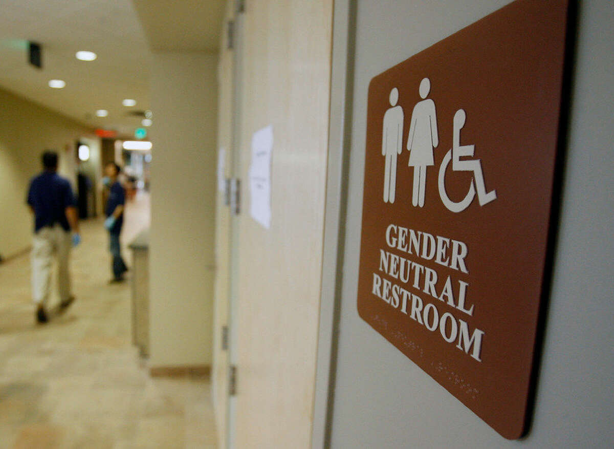 FILE- In this Aug. 23, 2007, file photo, a sign marks the entrance to a gender-neutral restroom at the University of Vermont in Burlington, Vt. Nearly all of the nation's 20 largest cities, including New York City, have local or state nondiscrimination laws that allow transgender people to use whatever bathroom they identify with, though a debate has raged around the topic nationwide. Bill de Blasio, a Democrat, signed an executive order on Monday, March 7, 2016, that guarantees people access to single-sex facilities consistent with their gender identity at city facilities, including offices, pools and recreation centers, without the need to show identification or any other proof of gender. (AP Photo/Toby Talbot, File)