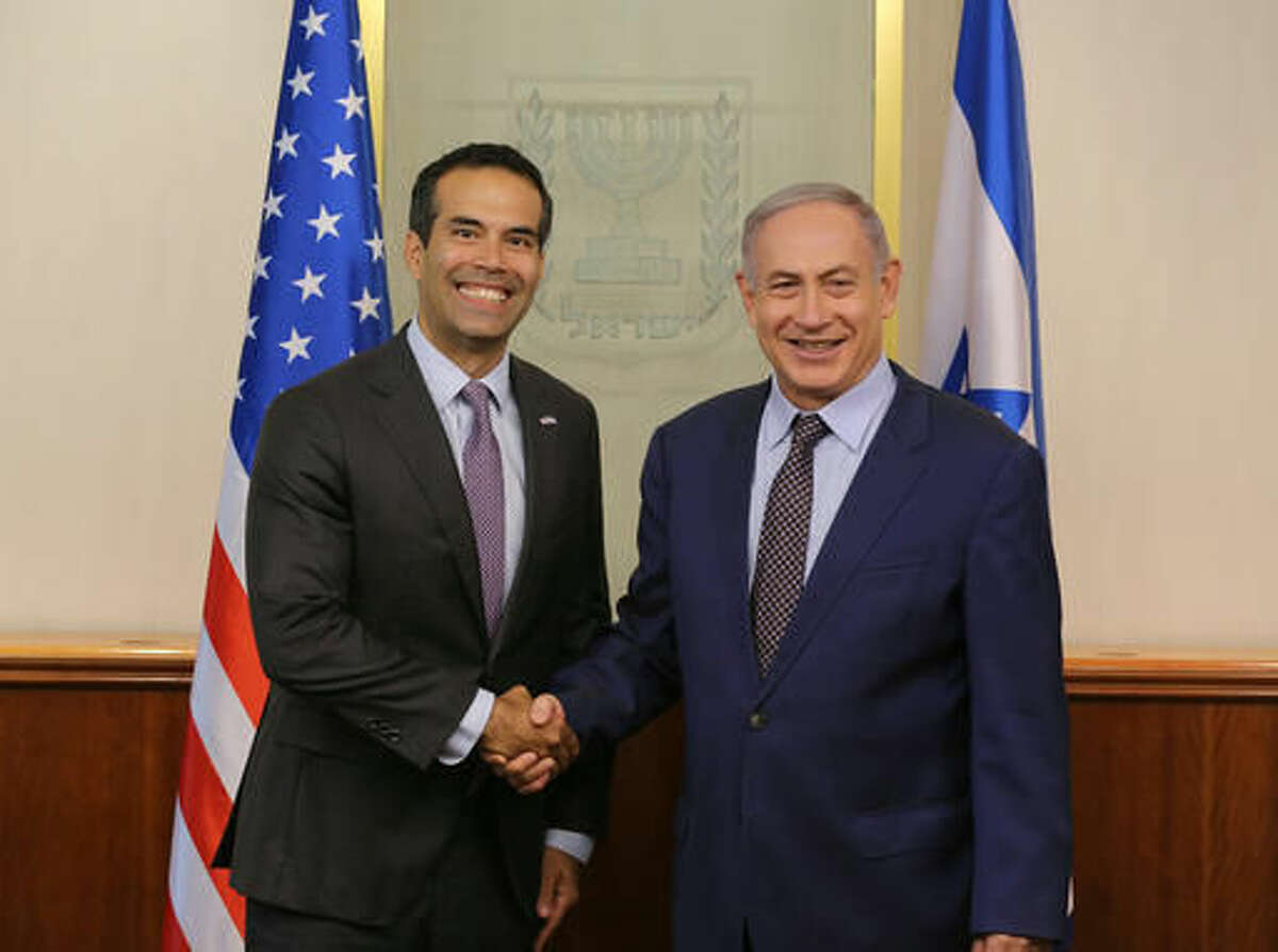 This Aug. 15, 2016 photo provided by the Israel Ministry of Foreign Affairs shows Texas Land Commissioner George P. Bush posing with Israeli Prime Minister Benjamin Netanyahu in Jerusalem. Bush, the son of former presidential candidate Jeb Bush, visited Israel last week in his first overseas trip since taking elected office last year, and thanked Netanyahu for "all he is doing to fight terrorism." (Avi Dodi/Israel Ministry of Foreign Affairs via AP)